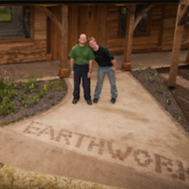 Two Earthworkers standing outside the lodge