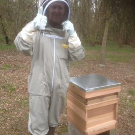 Philip Leach standing beside one of our beehives